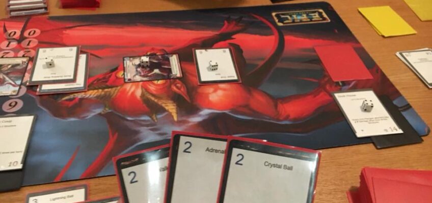 Calvin Keeney holding the defense cards as he plays the first game of Memaw's Monsters Tower Defense version 8 thousand